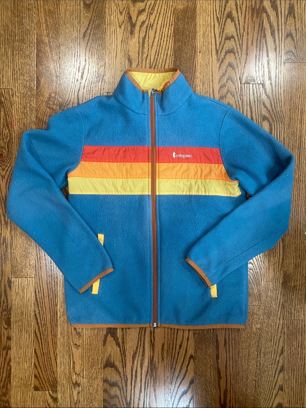 cotopaxi Teal Fleece Jacket with Orange and Yellow Chest Stripes, size L